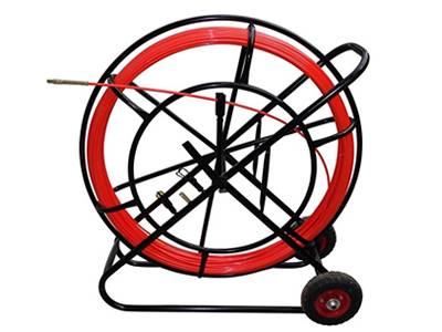 A duct rodder with red rubber wheel, red pulling rod, a hand brake on the carrier, also with duct rod grapples set and a drawing head.